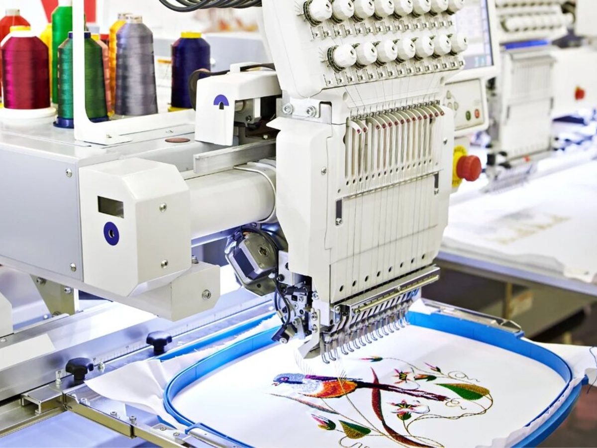 Multi-head embroidery machine running a production job