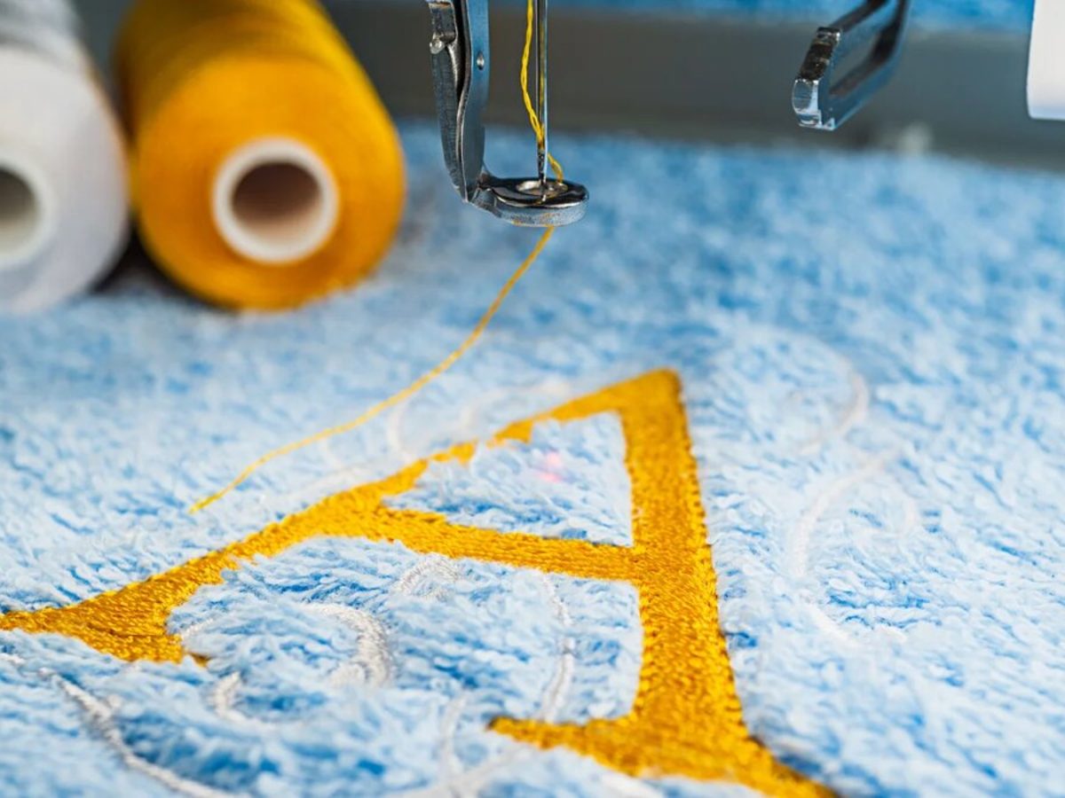 Script lettering embroidered on a white towel